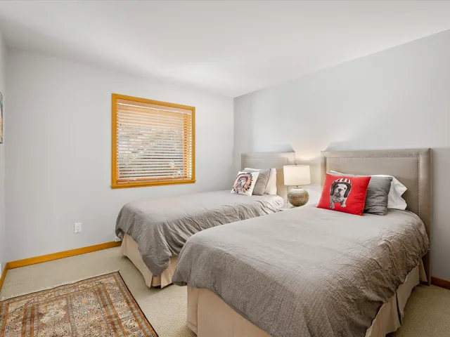 Bedroom featuring baseboards and carpet