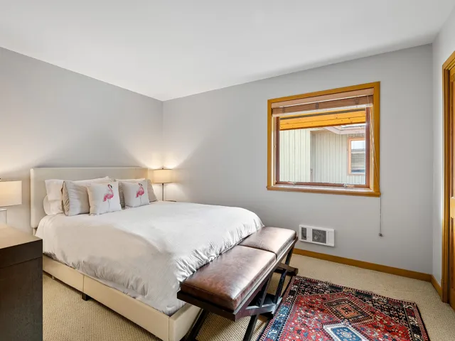 Bedroom with light colored carpet