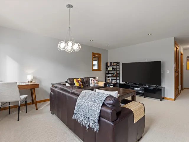 Living room featuring light carpet, a chandelier, and recessed lighting