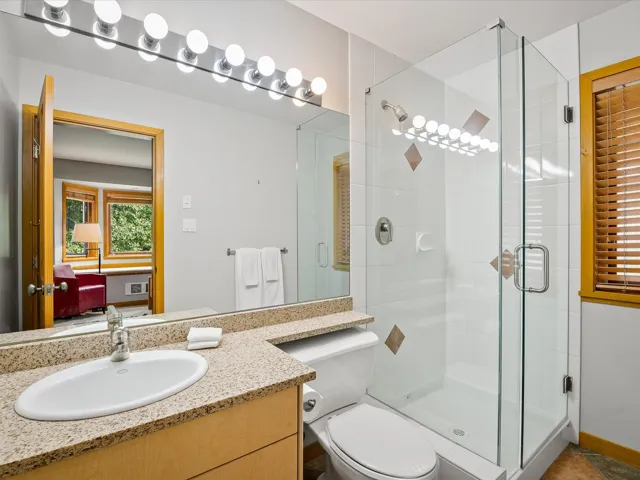 Bathroom with a stall shower and vanity