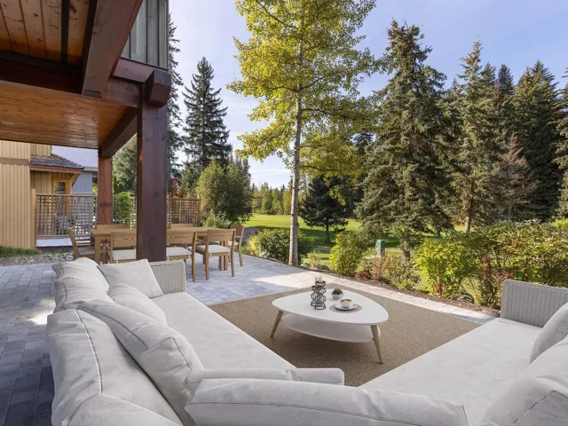 View of patio featuring an outdoor hangout area, outdoor dining area, and view of wooded area