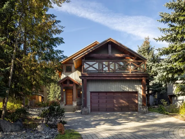 View of front of house with decorative driveway and a garage