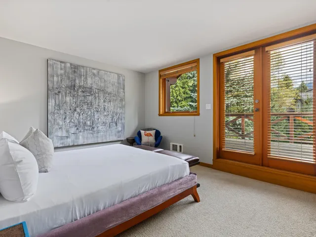 Carpeted bedroom with access to exterior and baseboards