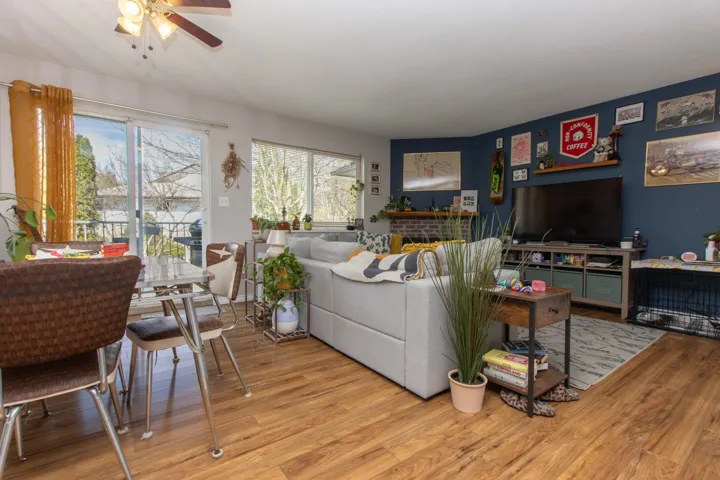 Living area with wood finished floors and ceiling fan