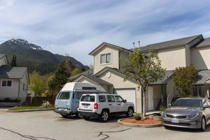 Traditional home featuring fence, driveway, a mountain view, and a garage