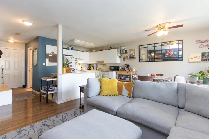 Living room featuring baseboards, a ceiling fan, and wood finished floors