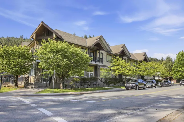 Contemporary multi-story building featuring stone accents and gabled rooflines