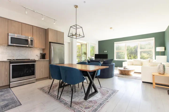 Dining room with a chandelier, track lighting, and light wood-style floors