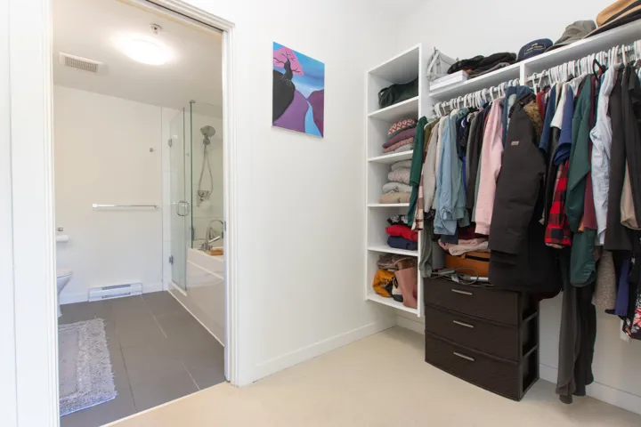 Walk in closet with tile patterned floors, visible vents, and a baseboard radiator