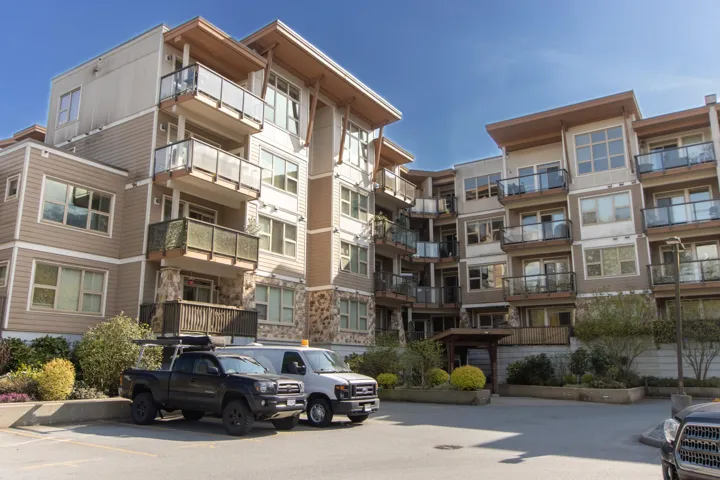 View of property featuring uncovered parking