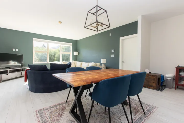 Dining area featuring a chandelier, lofted ceiling, and light wood finished floors