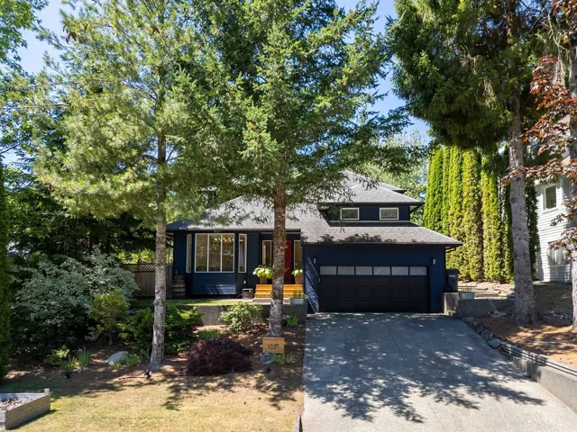 Tri-level home featuring driveway and an attached garage