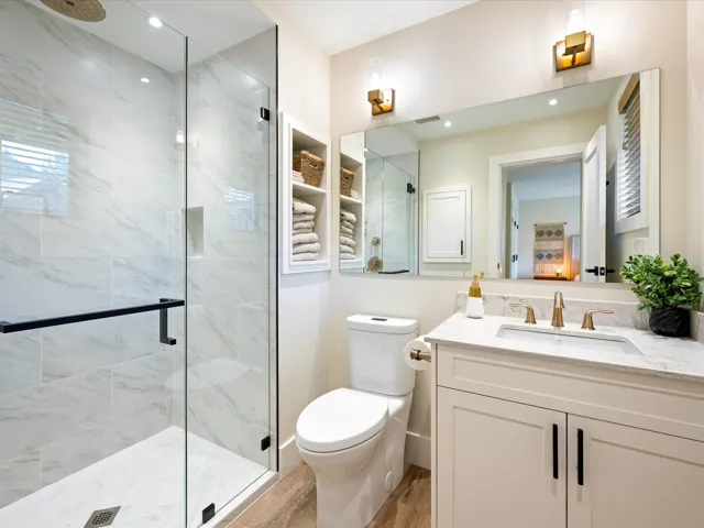 Full bathroom with a shower stall, vanity, and wood finished floors