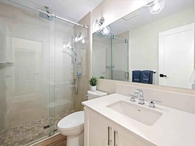 Bathroom featuring vanity and a stall shower