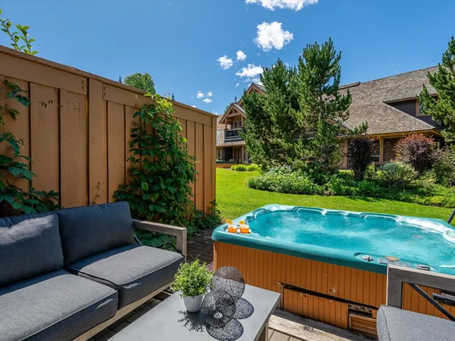 View of pool with a hot tub and a yard