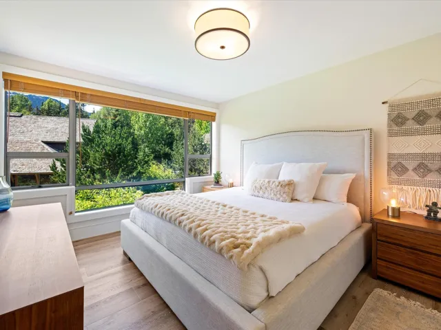 Bedroom featuring multiple windows and wood finished floors