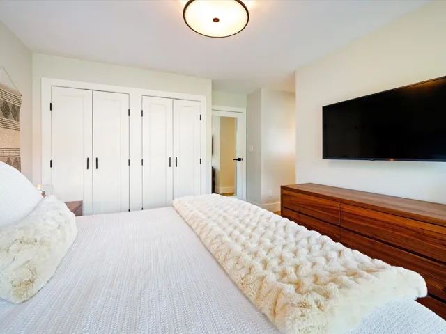 Bedroom featuring two closets and baseboards