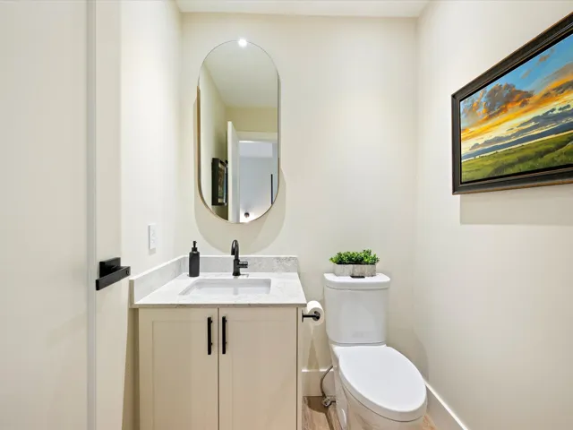 Half bath featuring vanity and toilet