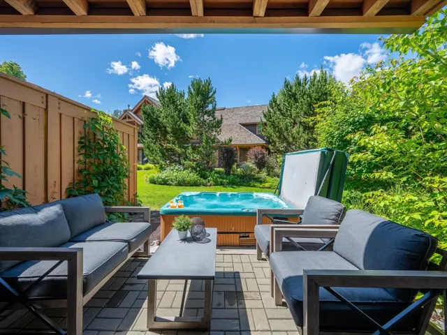 View of patio / terrace with a hot tub and an outdoor living space