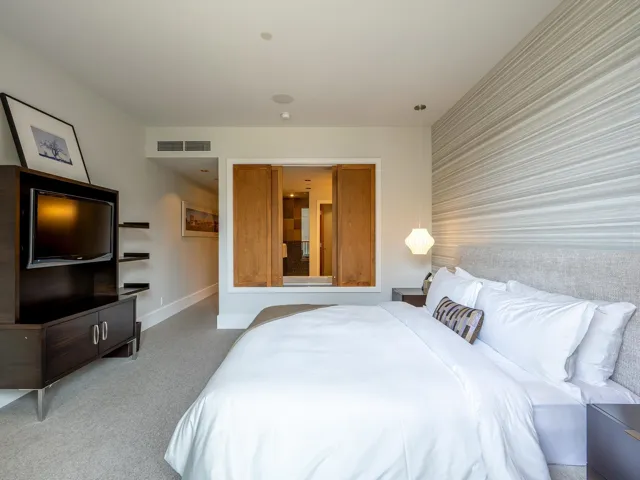 Bedroom with light carpet and baseboards