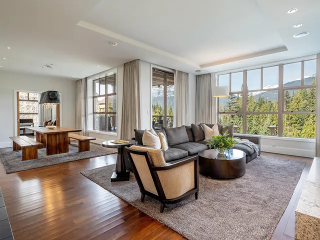 Living room featuring wood-type flooring, a raised ceiling, and recessed lighting