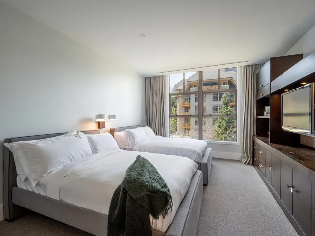 Bedroom featuring light carpet and baseboards