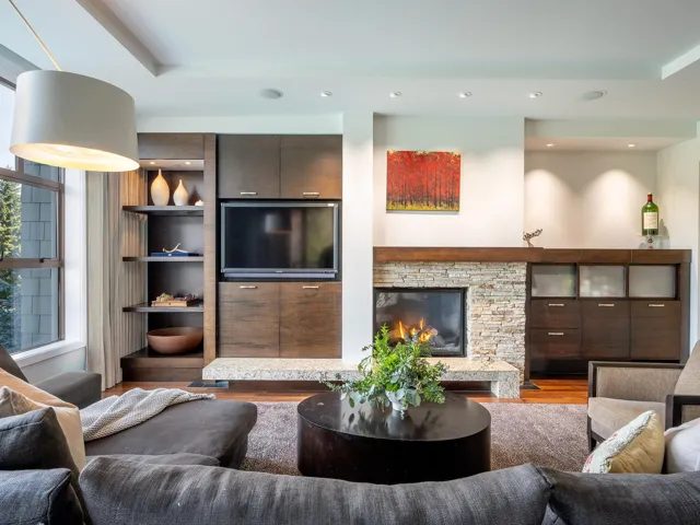 Living area featuring recessed lighting, a stone fireplace, and wood finished floors