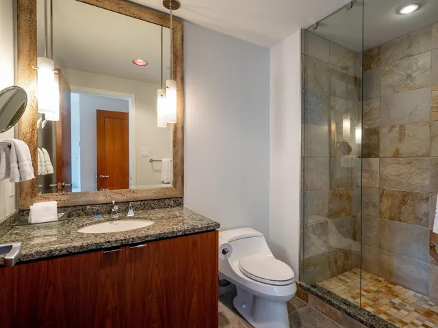Bathroom featuring vanity, recessed lighting, and a stall shower