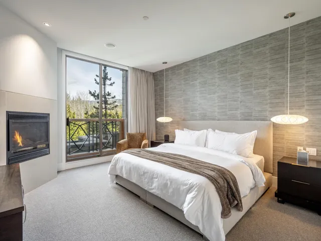 Carpeted bedroom with access to exterior, a fireplace, and recessed lighting