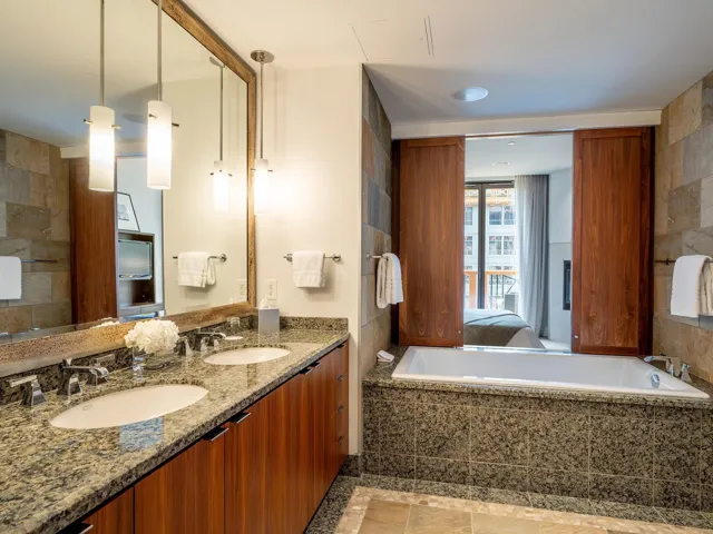Ensuite bathroom with double vanity and a relaxing tiled tub