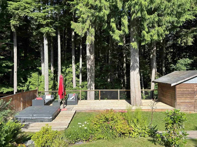 View of yard featuring a deck and an outdoor hangout area
