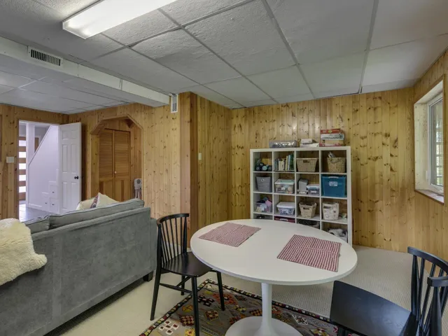 Dining area featuring wood walls and a paneled ceiling