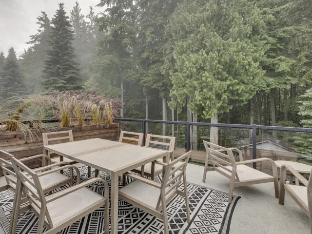 View of patio / terrace with outdoor dining space and a forest view