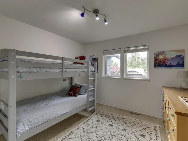 Bedroom with baseboards and light colored carpet