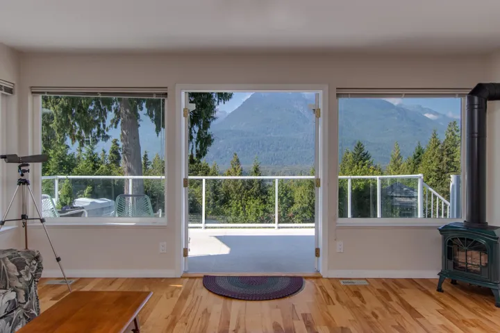 Doorway featuring a mountain view, wood finished floors, and a wood stove