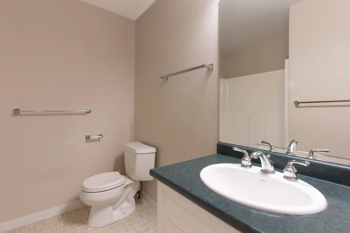 Full bath with vanity and light tile patterned flooring