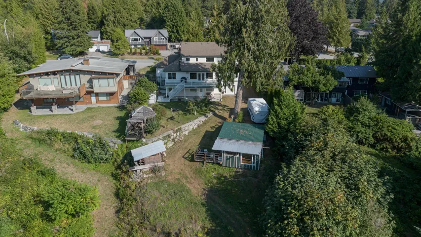 Aerial view of property and surrounding area with nearby suburban area