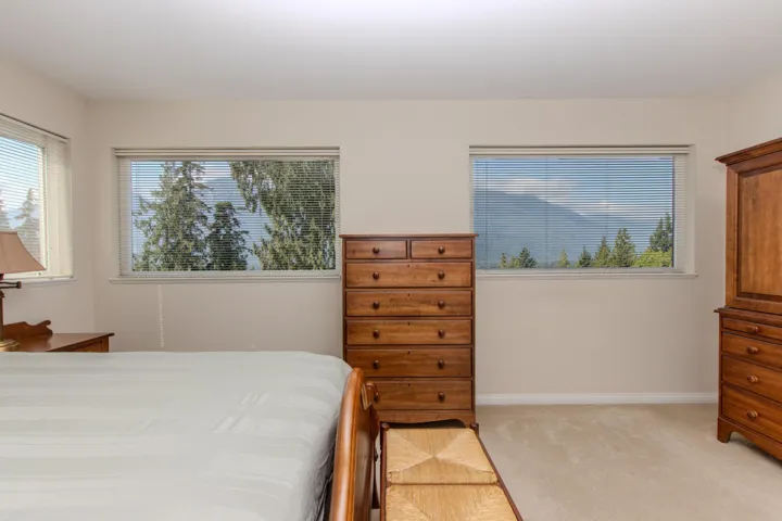 Bedroom with light colored carpet and baseboards