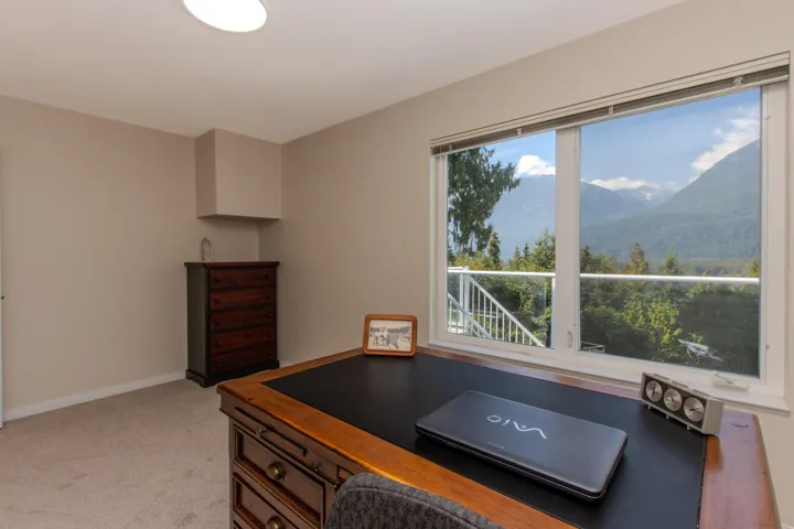 Office featuring light colored carpet and a mountain view