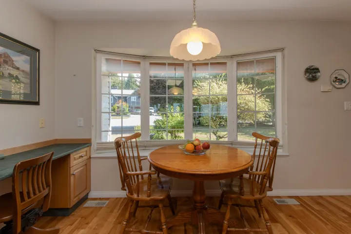 Dining area with light wood finished floors and an office area