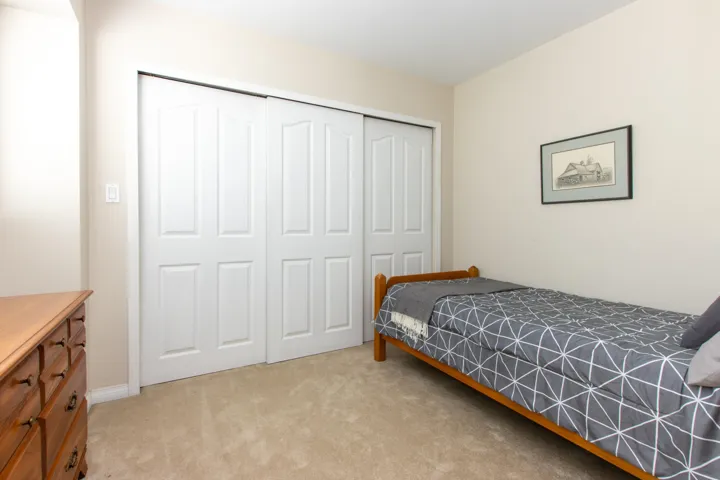 Bedroom with a closet and light colored carpet