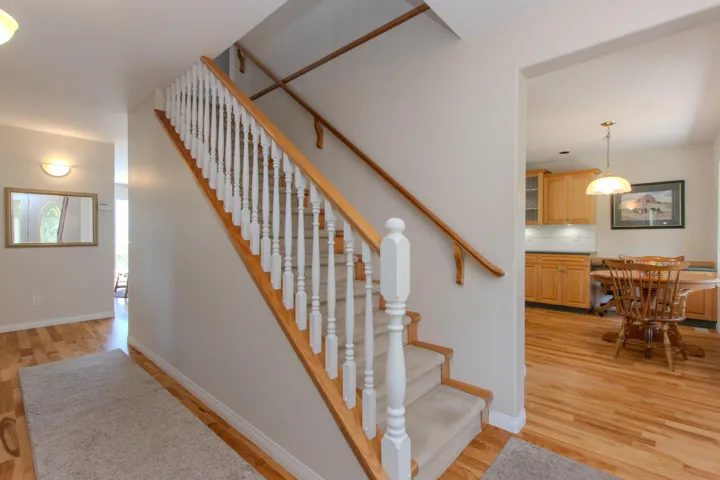 Stairway featuring wood finished floors and baseboards