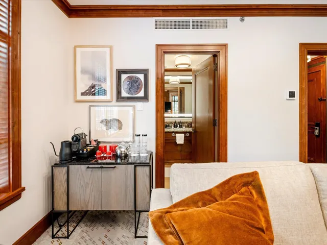 Hall featuring visible vents, baseboards, and ornamental molding