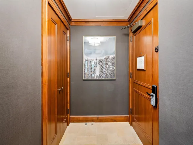 Doorway to outside with ornamental molding and baseboards