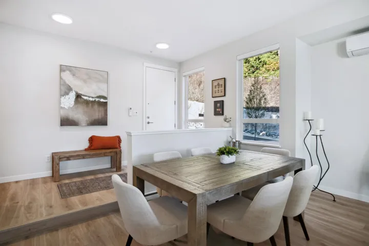 Dining space featuring wood finished floors, baseboards, a wall mounted AC, and recessed lighting