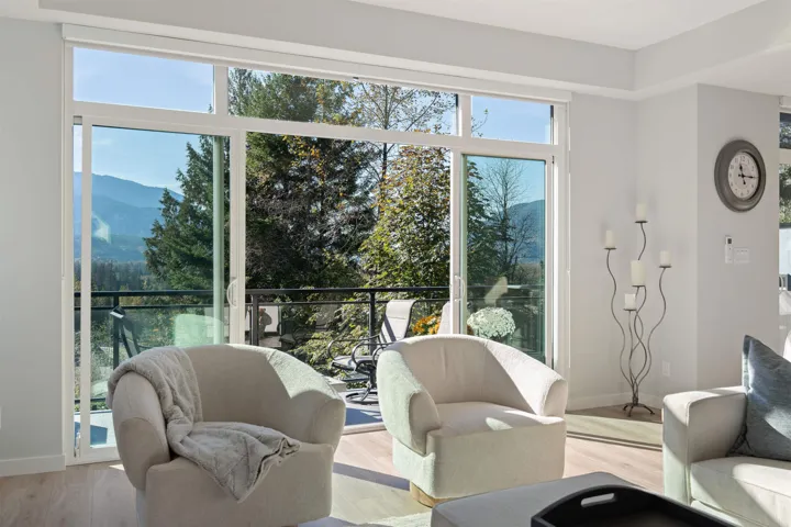 Living room with light wood-style floors, baseboards, and a mountain view
