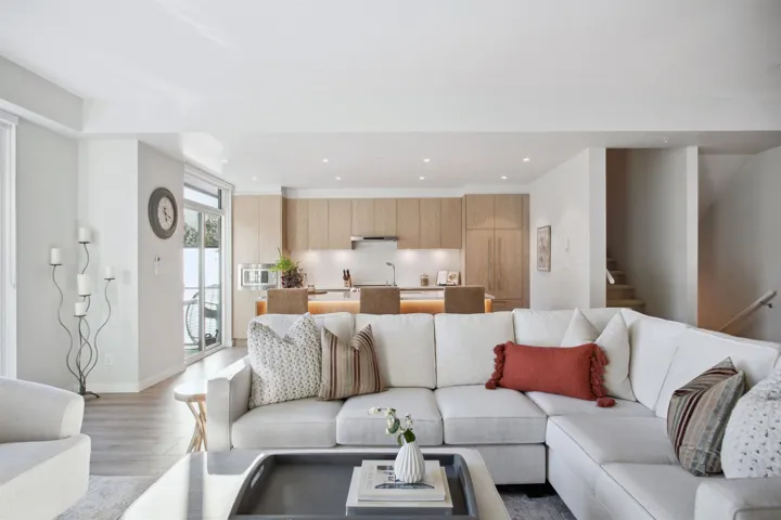 Living area featuring light wood-style floors, stairs, recessed lighting, and baseboards