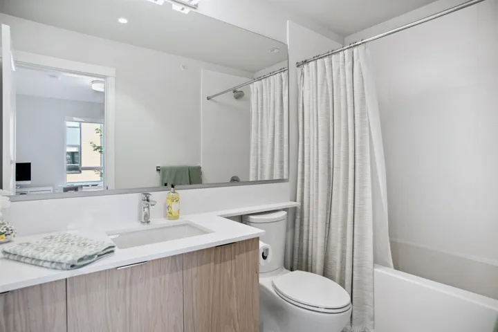 Full bath featuring toilet, shower / bath combo, and vanity