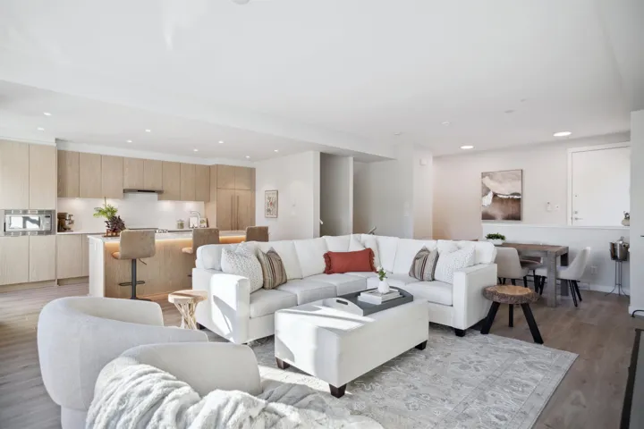 Living area with light wood finished floors and recessed lighting