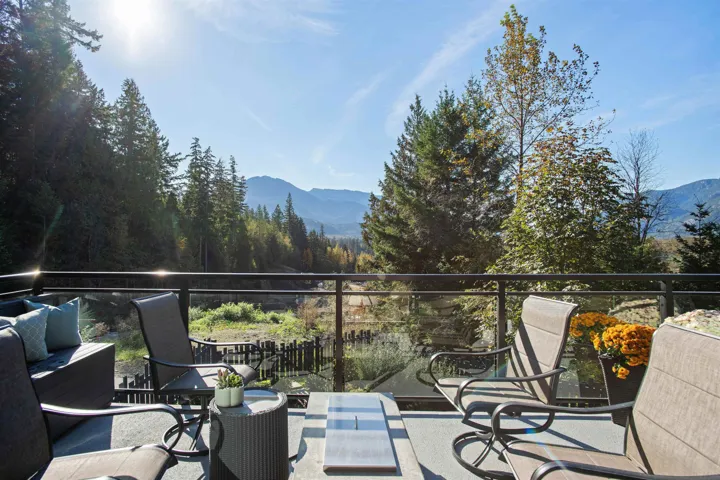 View of patio with a mountain view and a balcony